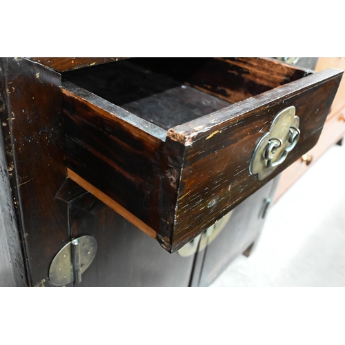 30 - An old Chinese stained hardwood and brass mounted cabinet, with two drawers over cupboard doors, 90 ... 