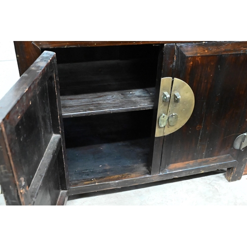 30 - An old Chinese stained hardwood and brass mounted cabinet, with two drawers over cupboard doors, 90 ... 