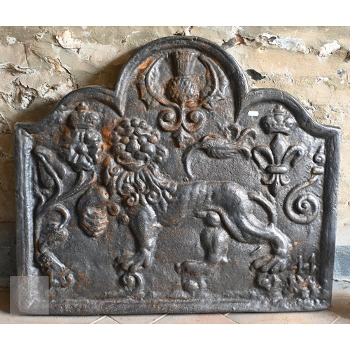 35 - A traditional cast iron fireback with heraldic lion and thistle design