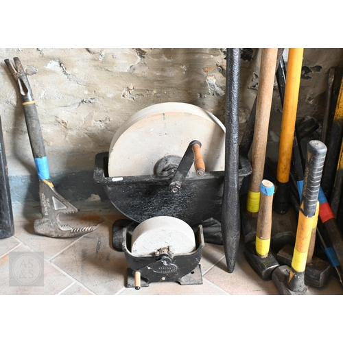 36 - Assorted used hand tools including crow/pry bars, club and sledgehammers, two grinding/sharpening wh... 