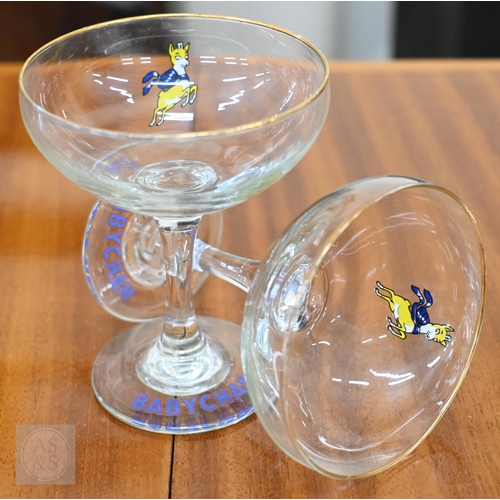 410 - An original boxed Babycham six Glass Party Pack to/w a printed linen Babycham barmaid's apron