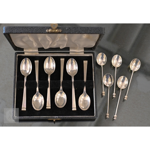 420A - A cased set of six silver teaspoons, Sheffield 1958, to/w five coffee spoons with thistle finials, B... 