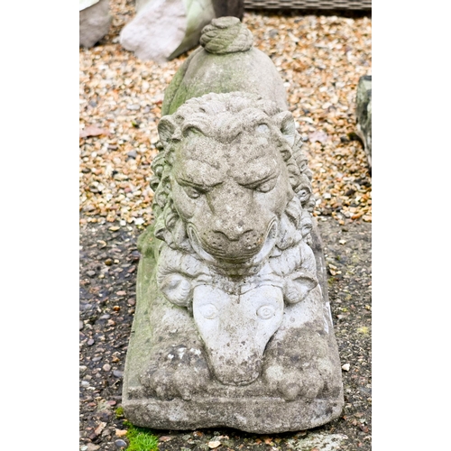 5 - A weathered cast stone garden statue of a recumbent lion