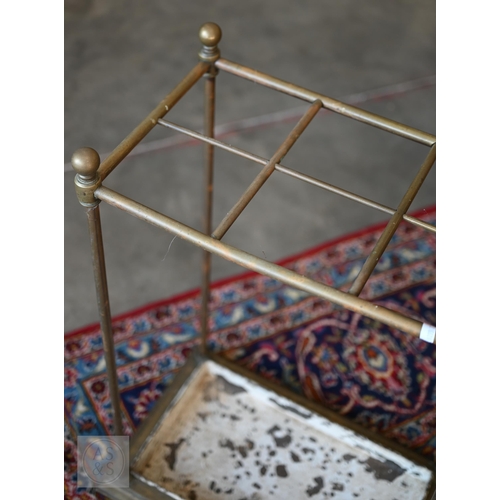 51 - A brass six division unbrella/stick stand with painted drip tray base, 42 x 26 x 65 cm h