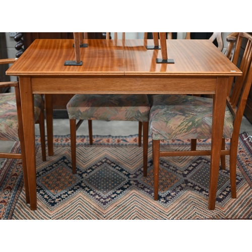 59 - A Mid-Century Gordon Russell teak extending dining table with optional central leaf (slides undernea... 