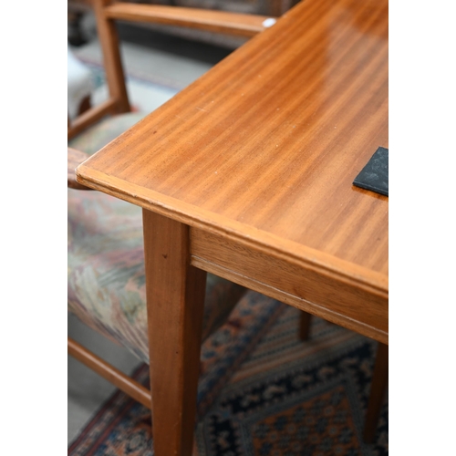 59 - A Mid-Century Gordon Russell teak extending dining table with optional central leaf (slides undernea... 