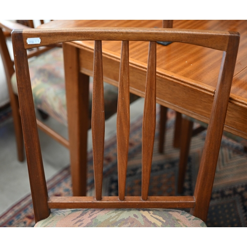 59 - A Mid-Century Gordon Russell teak extending dining table with optional central leaf (slides undernea... 