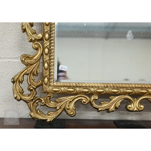 60 - A Florentine style gilt framed mirror with bevelled glass, 100 x 74 cm