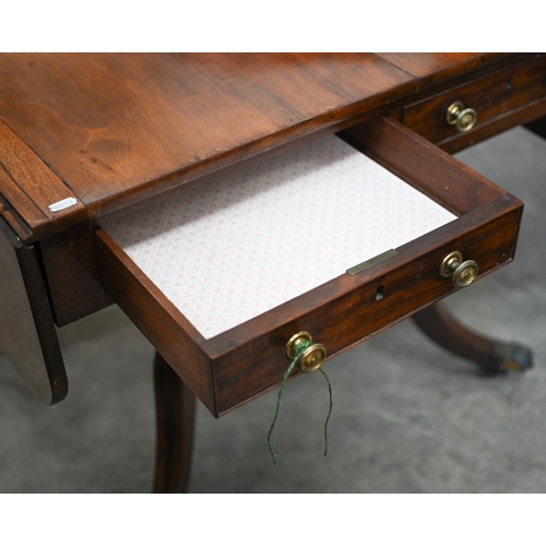 72 - A Regency mahogany sofa table with two drawers and quadraform base with turned pillars and out-swept... 