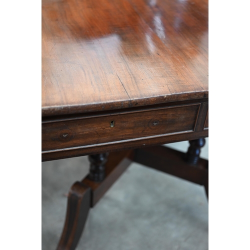 72 - A Regency mahogany sofa table with two drawers and quadraform base with turned pillars and out-swept... 