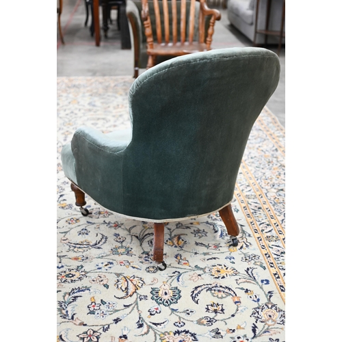 74 - A Victorian nursing chair upholstered with green button back fabric