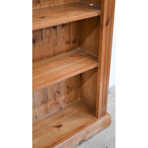 77 - A stained pine open bookcase with moulded cornice and five fixed shelves, 142 cm w x 30 cm d x 186 c... 