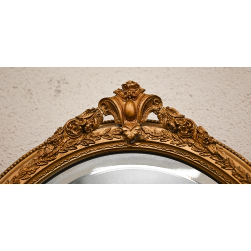 78 - A pair of bevelled oval wall mirrors in decorative laurel design giltwood and gesso frames, 44 cm w ... 