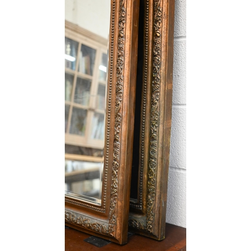 82 - A pair of Rococo style bevelled mirrors in giltwood and composite moulded foliate frames with shell ... 