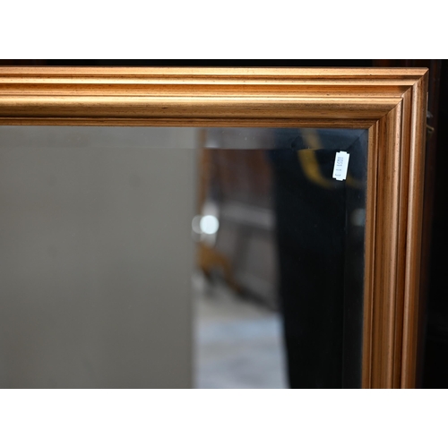 86 - A large modern bevelled mirror in moulded giltwood frame, 110 cm x 85 cm