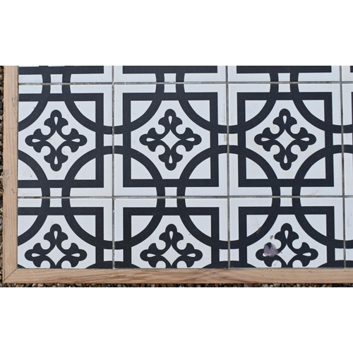 89 - A stained wood rectangular reception coffee table with black and white encaustic style tiled top, 18... 