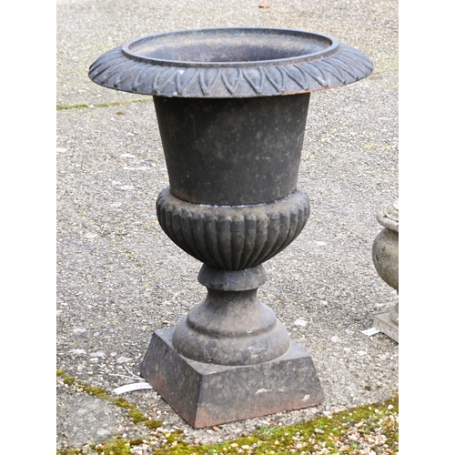 9 - A weathered black patinated cast iron urn planter to/w a small bulbous stone urn planter (2)