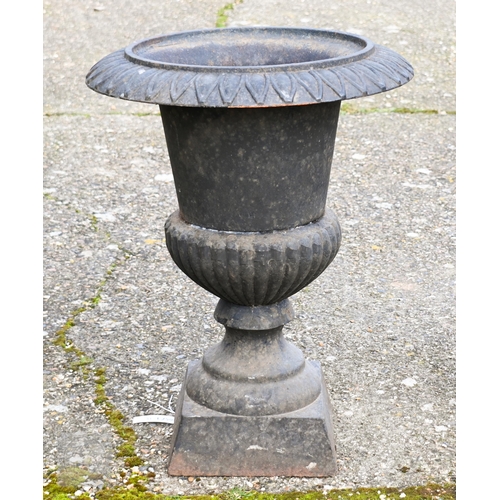 9 - A weathered black patinated cast iron urn planter to/w a small bulbous stone urn planter (2)