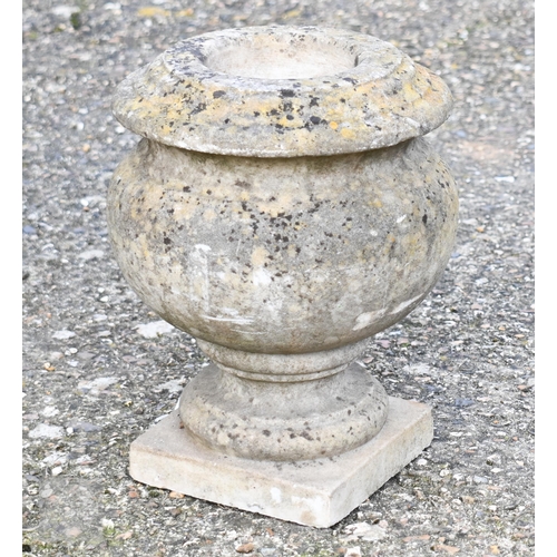 9 - A weathered black patinated cast iron urn planter to/w a small bulbous stone urn planter (2)