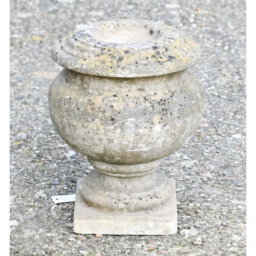 9 - A weathered black patinated cast iron urn planter to/w a small bulbous stone urn planter (2)