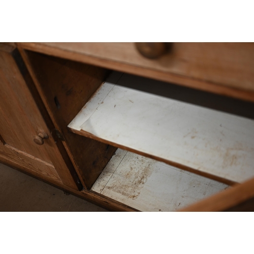 90 - An antique pine dresser base with two drawers over panelled cupboard doors, 158 cm w x 64 cm d x 92 ... 