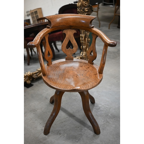 97 - An antique lyre back captain's swivel desk chair with shaped elm seat