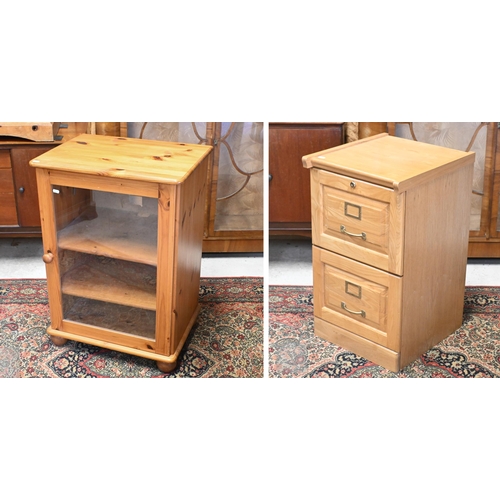 134 - A stained pine media cabinet with glazed door and bun feet, 58 x 44 x 80 cm high to/w two drawer fil... 