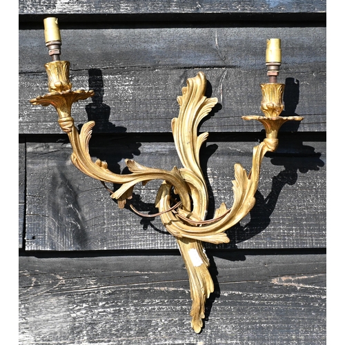 277 - A pair of Rococo style gilt metal twin branch asymmetric design wall sconces, 45 cm h