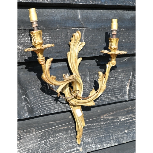 277 - A pair of Rococo style gilt metal twin branch asymmetric design wall sconces, 45 cm h