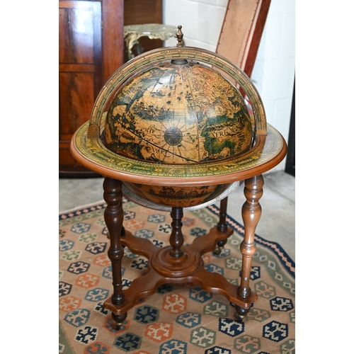 290 - A vintage hardwood globe drinks cabinet with half hinged top enclosing fitted interior