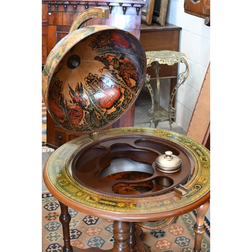 290 - A vintage hardwood globe drinks cabinet with half hinged top enclosing fitted interior