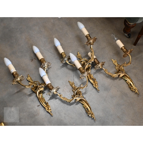 294 - A set of four gilt metal Rococo style twin branch wall lights