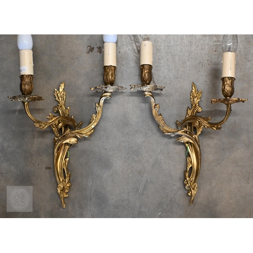 294 - A set of four gilt metal Rococo style twin branch wall lights