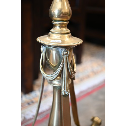 296 - A polished brass standard lamp on scrolling triform base with Neoclassical ribbon swags, 180 cm h