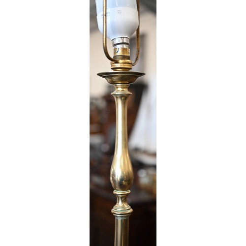 296 - A polished brass standard lamp on scrolling triform base with Neoclassical ribbon swags, 180 cm h