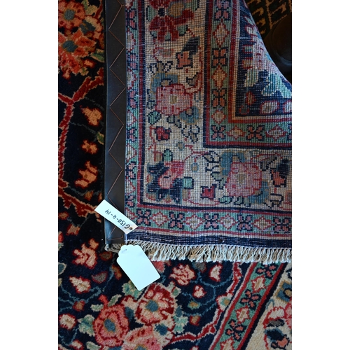 634 - A North West Persian Sarouk rug, floral design on blue ground, cream border with alternating rosette... 