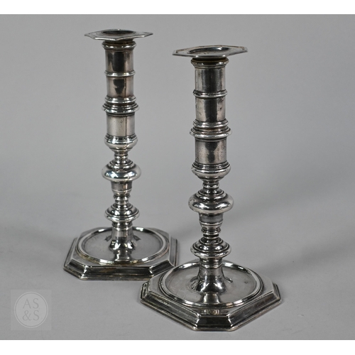 A pair of James II cast silver baluster candlesticks, the dished square bases with canted corners, Peter Harache, London 1685, 25oz, 16cm high; lot includes a bespoke pair of detachable extension pieces, each 8.5cm high, Peter & Ann Bateman, London 1797 and a pair of unmarked detachable grease-pans, 31oz all in, 22cm high o/a