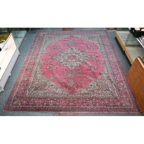 632 - A large Turkish pink ground carpet, large central floral medallion with conforming spandrels and ope... 