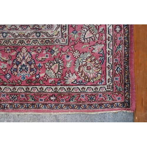 632 - A large Turkish pink ground carpet, large central floral medallion with conforming spandrels and ope... 
