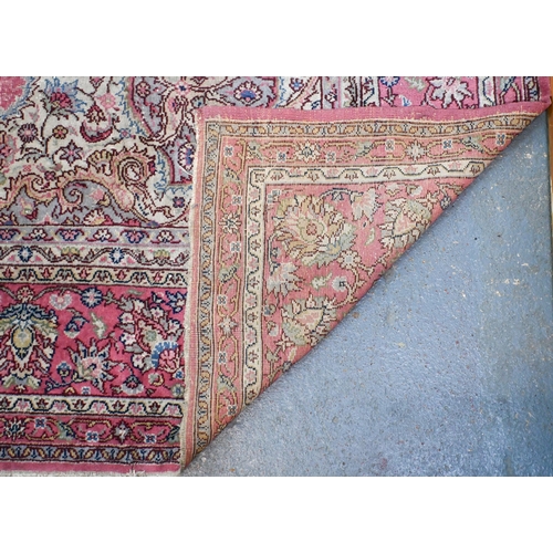 632 - A large Turkish pink ground carpet, large central floral medallion with conforming spandrels and ope... 