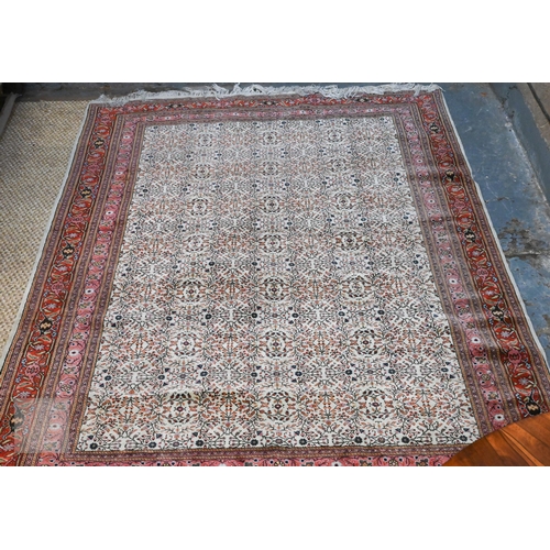 638 - A fine Hereke handmade carpet, all over design on cream ground within red/pink borders 287 x 203 cm