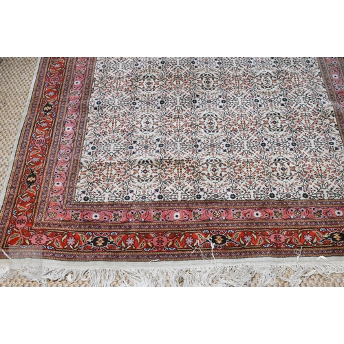 638 - A fine Hereke handmade carpet, all over design on cream ground within red/pink borders 287 x 203 cm