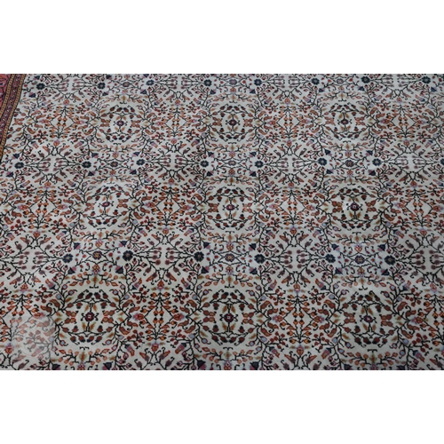 638 - A fine Hereke handmade carpet, all over design on cream ground within red/pink borders 287 x 203 cm