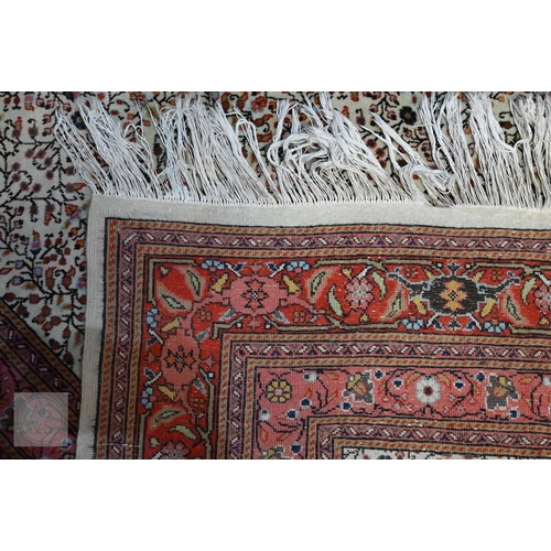 638 - A fine Hereke handmade carpet, all over design on cream ground within red/pink borders 287 x 203 cm