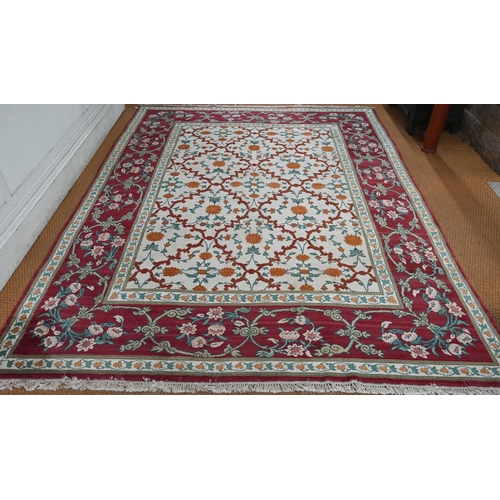 643 - An Indo-Persian Agra carpet with floral herati design on camel ground with red floral scroll border,... 