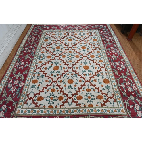 643 - An Indo-Persian Agra carpet with floral herati design on camel ground with red floral scroll border,... 