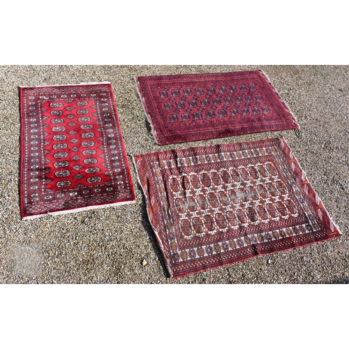 645 - Three old Turk/Afghan rugs, red ground, sizes 183 cm x 106 cm; 188 cm x 125 cm; 158 cm x 99 cm (3)