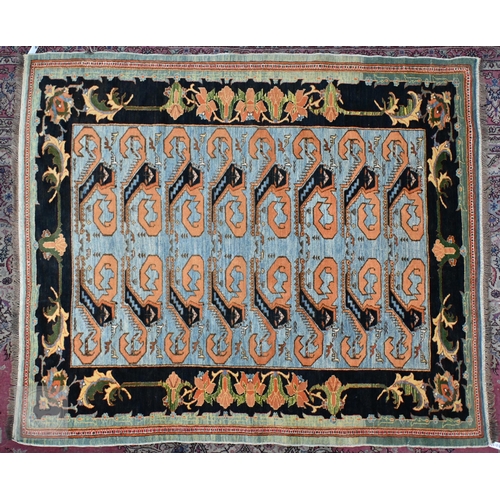 650 - A vintage powder blue ground rug with palmette border, 198 cm x 170 cm