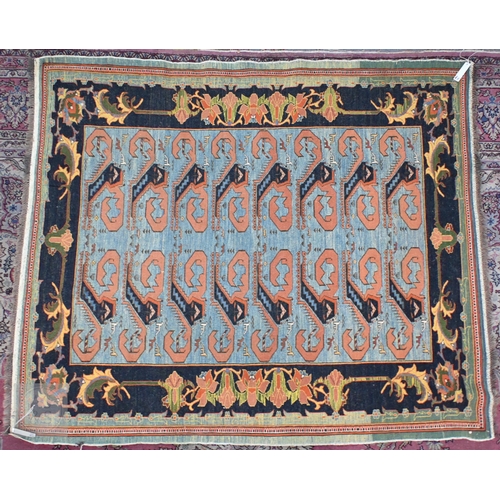 650 - A vintage powder blue ground rug with palmette border, 198 cm x 170 cm