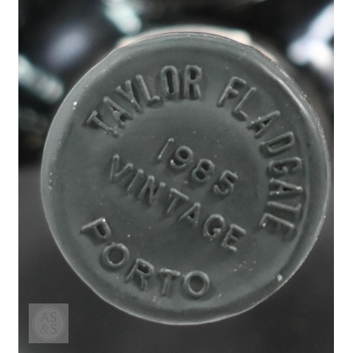 860 - Eleven bottles 1985 vintage Taylors Port, in original wooden case No warranty offered as to conditio... 